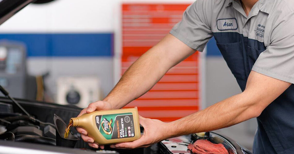 Hyundai service technician performing an oil change