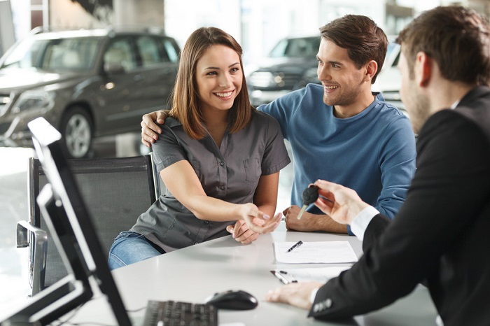 Customer receiving keys to a new car at our Hyundai dealership